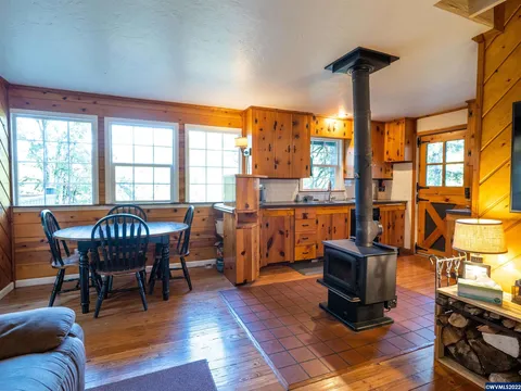 A-frame cabin dining area with wood stove